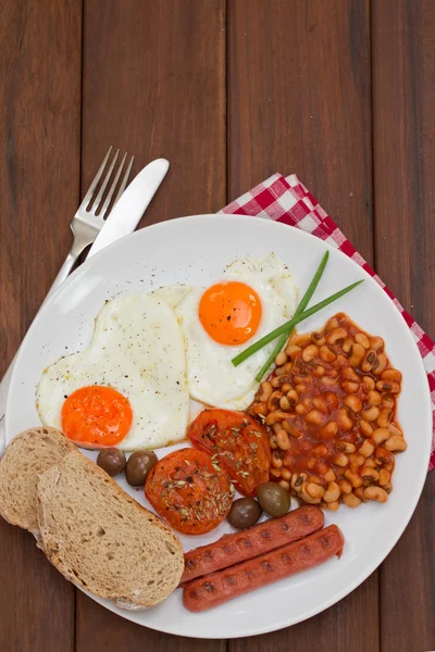 Gebakken eieren met brood, worst en bonen op witte plaat — Stockfoto