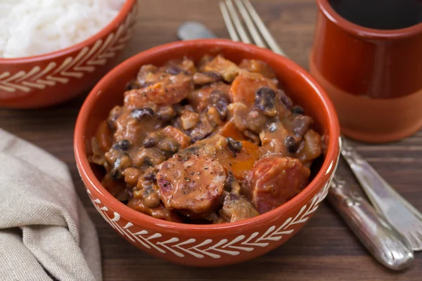 typical portuguese dish feijoada in ceramic brown bowl