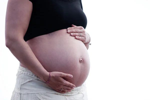 Woman holding hands over belly — Stock Photo, Image