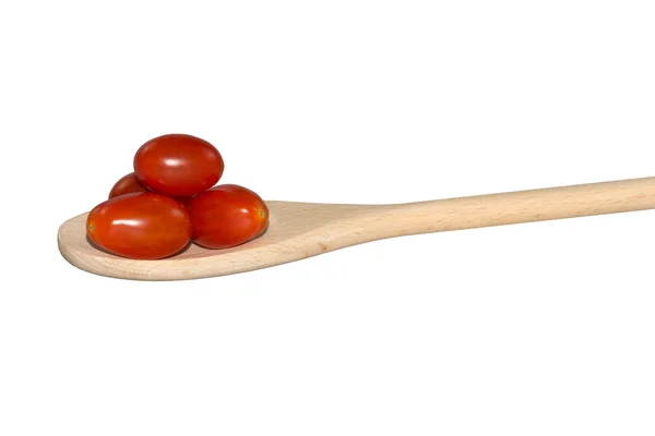 Pomodori d'uva su un cucchiaio di legno leggero — Foto Stock