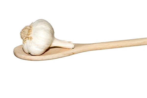 Garlic on a light wooden spoon — Stock Photo, Image