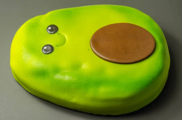 一种鳄梨形状的蛋糕 带有一层巧克力味的海绵 上面涂满了绿色软糖和可食用的装饰 还有派对蛋糕 — 图库照片