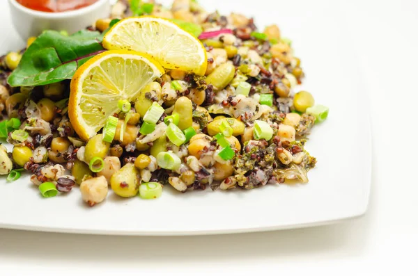 Cooked edamame beans, chickpeas, pearl barley, red quinoa, mung beans and black rice in a refreshing lemon dressing, healthy salad