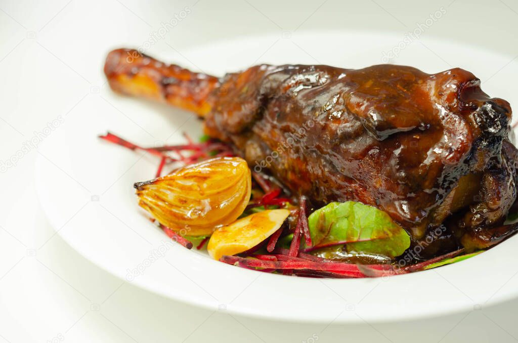 Delicious Lamb shank with red wine and rosemary gravy served on the mixed leaf salad, exclusive dish