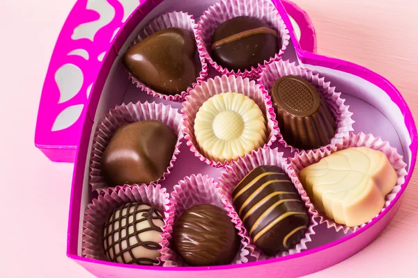 Chocolates in heart shaped box — Stock Photo, Image