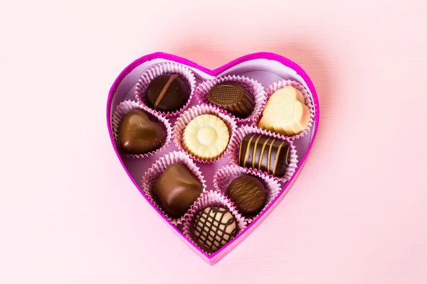 Chocolates in heart shaped box — Stock Photo, Image