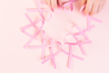 Womens health symbol in pink ribbons clipart