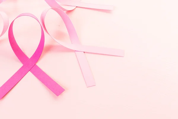 Womens health symbol in pink ribbons