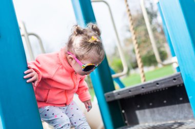 Oyun parkında oynayan yürümeye başlayan çocuk