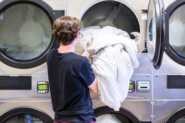 Teenage boy doing the laundry — Stock Photo, Image