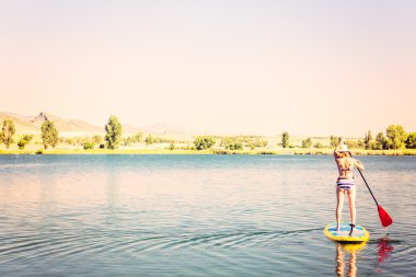 Genç kadın Paddleboarding