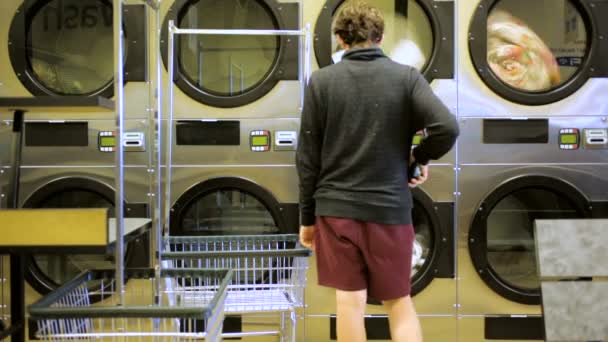 Industrial washing machines in a public laundromat. — Stock Video