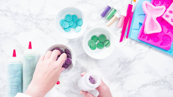Melting color chocolate chips for making mermaid chocolate molds.