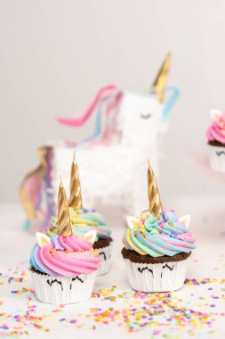 Renkli tereyağlı kremayla süslenmiş tek boynuzlu at kekleri..