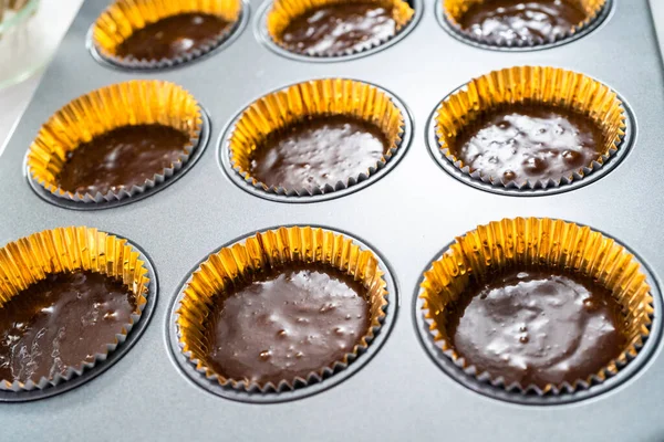 Baking chocolate cupcakes in cupcake pan.