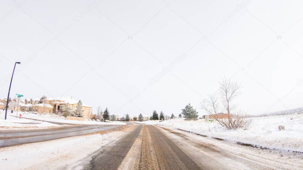 Driving on typical paved roads in a suburban upscale residential neighborhood of America.