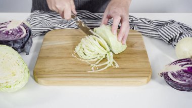 Adım adım. Ağaç kesme tahtasıyla organik lahana doğruyorum..