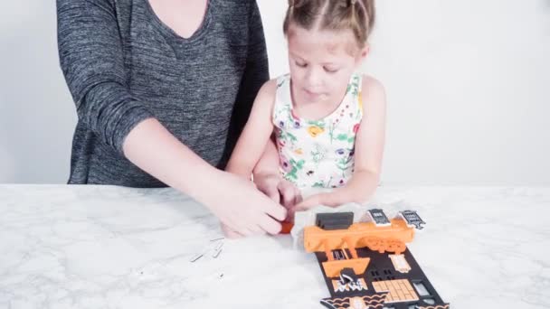 Little Girl Her Mother Working Halloween Craft Project — Stock Video