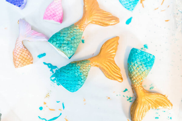 Mermaid tails made out of modeling clay and painted with acrylic paint.