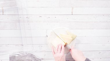 Düz yatıyordu. Adım adım. Mutfak bıçağıyla beyaz bir kesme tahtasının üzerinde gurme peyniri dilimlemek..