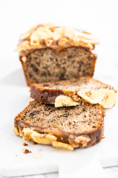 Sliced Banana Nut Bread Drizzled Homemade Caramel Marble Cutting Board — Stock Photo, Image