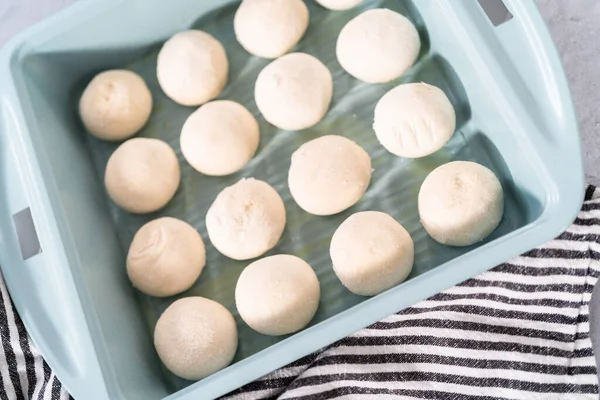 Baking dinner rolls from the premade frozen dough in the baking pan.