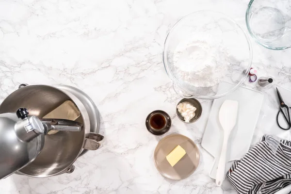 Flat lay. Flat lay. Preparing cream cheese frosting to decorate red velvet cupcakes.