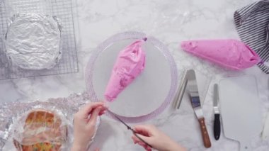 Yuvarlak konfeti pastasını pembe ve beyaz kar taneleriyle süslüyor..