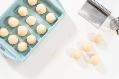 Beyaz bir tezgahın üzerinde mayalı hamurla yemek pişiriyorum..