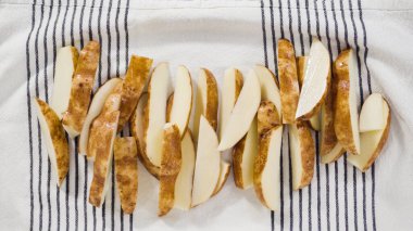 Düz yatıyordu. Adım adım. Fırında pişirmek için zeytinyağı ve baharatlı patatesler hazırlıyorum..