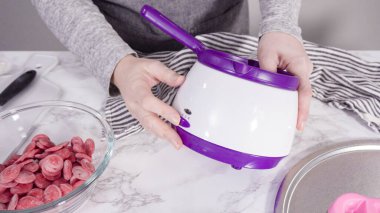 Adım adım. Çikolata kalıplı şekiller için erimiş kırmızı çikolata parçaları..