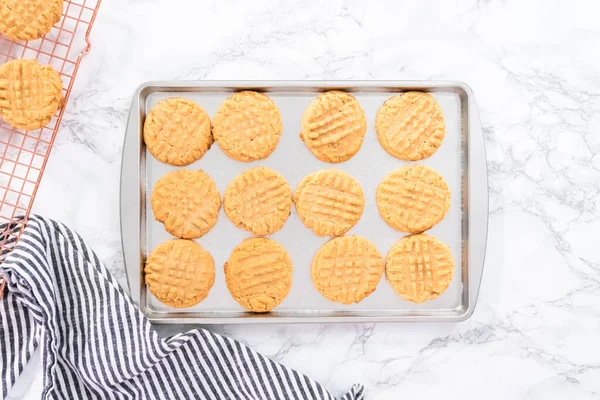 Flat lay. Freshly baked peanut butter cookies on a baking sheet.
