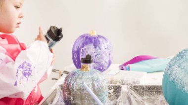 Adım adım. Küçük kız Cadılar Bayramı 'nda deniz kızı temalı balkabakları süslüyor..