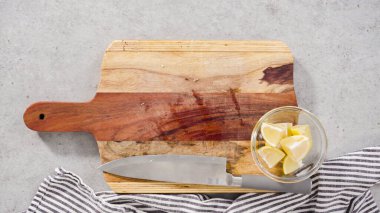 Ağaç kesme tahtasıyla organik limon kesmek.