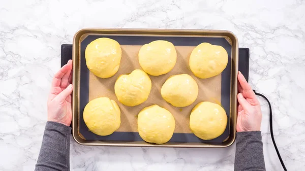 Flat lay. Step by step. Rising brioche dough on a baking sheet with a silicone mat.