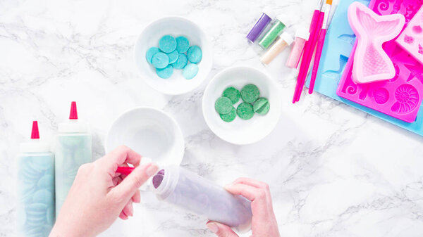 Melting color chocolate chips for making mermaid chocolate molds.