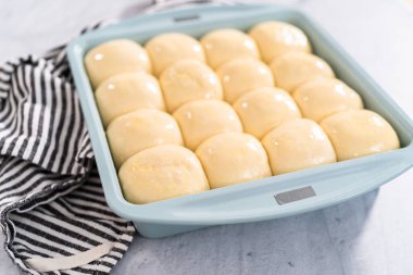 Fırında pişirmeden önce yumurta ve süt karışımıyla yemek rulolarını fırçalamak.