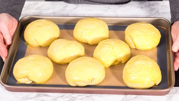 Step by step. Rising brioche dough on a baking sheet with a silicone mat.