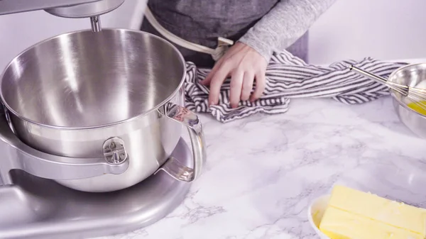 Step by step. Mixing ingredients in standing electric mixer for baking peanut butter cookies.