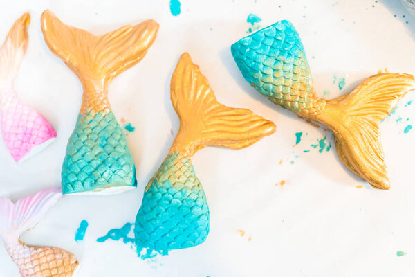 Mermaid tails made out of modeling clay and painted with acrylic paint.