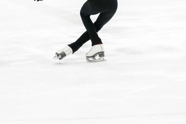 View of figure skater feet at the figure skating practice.