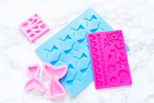 Mermaid theme silicone molds with sea stars and memaid tails.