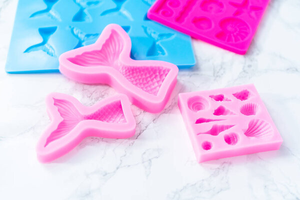 Mermaid theme silicone molds with sea stars and memaid tails.