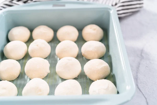 Baking dinner rolls from the premade frozen dough in the baking pan.