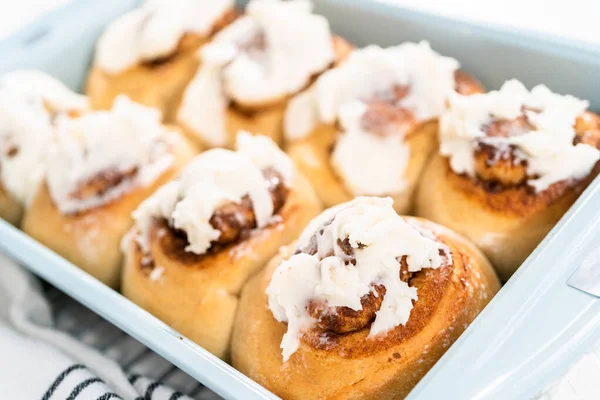 Vers Gebakken Kaneelbroodjes Met Witte Glazuur Een Blauwe Bakvorm — Stockfoto