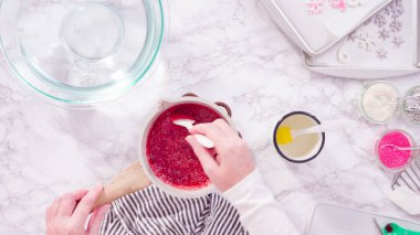 Düz yatıyordu. Adım adım. Ev yapımı lolipoplar yapmak için gıda tadını karamelize şekere karıştırmak.