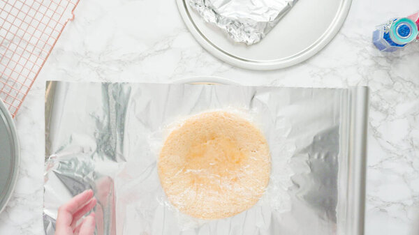 Step by step. Flat lay. Wrapping freshly baked cake layers into clear food wra