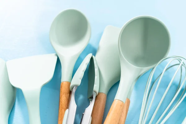 New Blue Silicone Kitchen Utensils Wooden Handles Blue Background — Stock Photo, Image