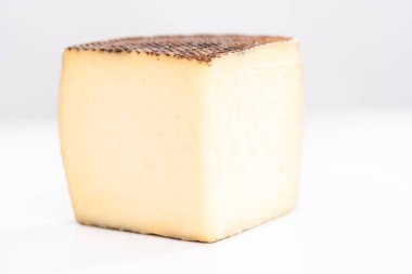 Large slice of aged Manchego cheese on a white background. clipart