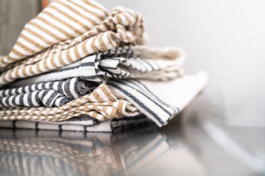 Stack of clean kitchen towels on the counter.